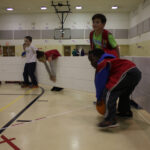Children playing gaga ball indoors with Octopit