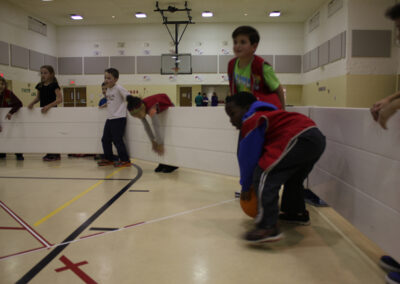 Children playing gaga ball indoors with Octopit